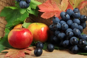 ripe apples and bunch of grapes on wood