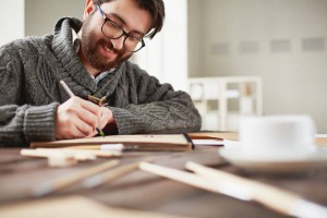 happy man drawing at his desk