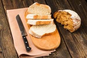 fresh white bread and brown bread on wooden background