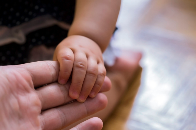 man holding childs hand