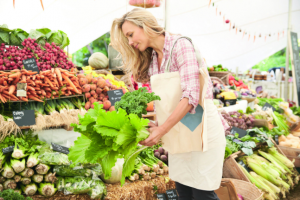 Female Customer Shopping At Farmers Market Stall