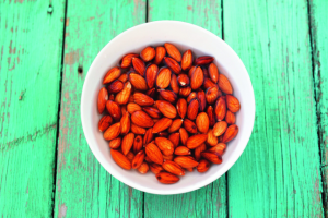 Wet Raw food nuts Almonds On Turquoise Wooden Table