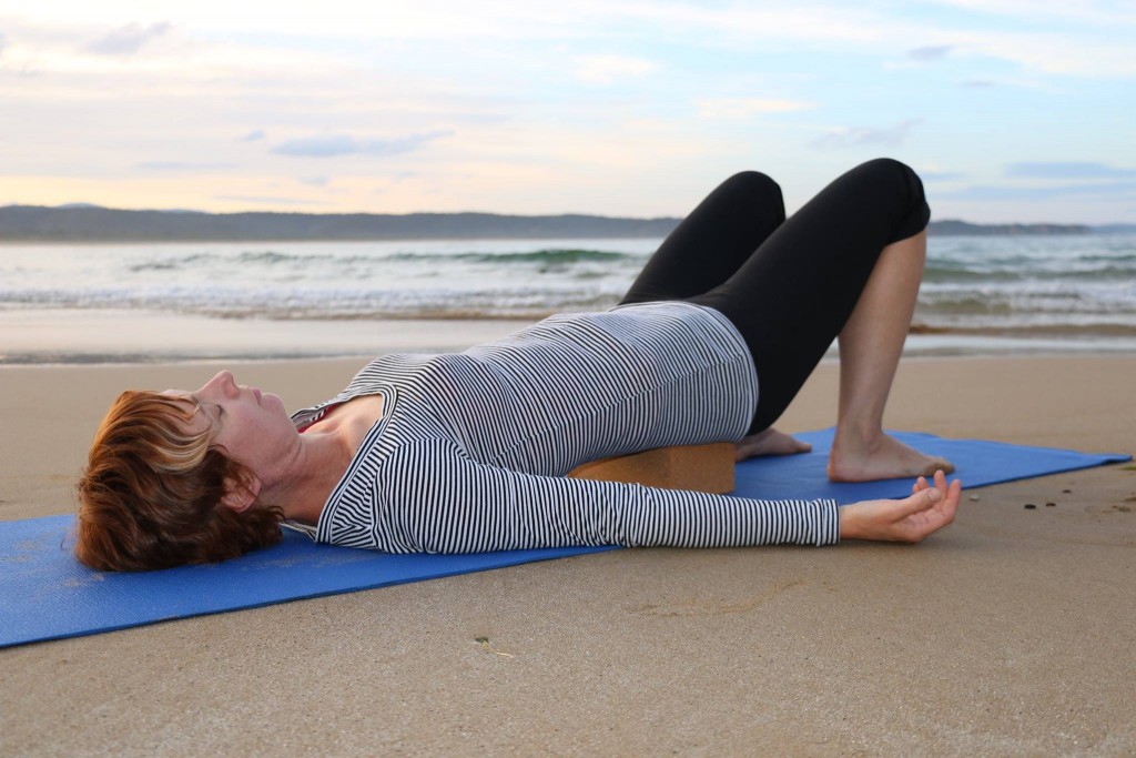 Bridge pose on beach