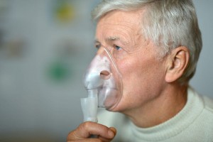 elder man making inhalation