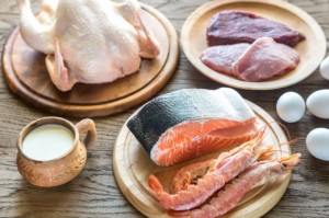 Meat, poultry, fish and shellfish in plates on a table