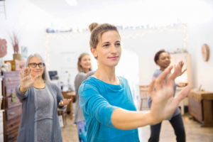 Women practicing tai chi in exercise class