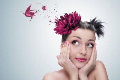 young woman with a flower on her head thinking