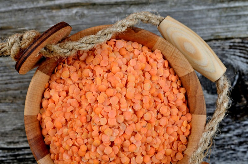 red lentil in bucket on wooden table