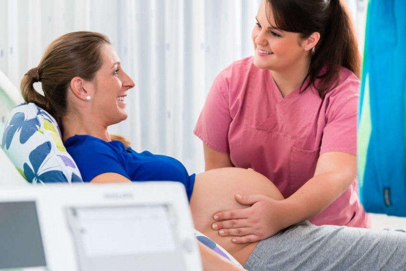 Pregnant woman in delivery room receiving care