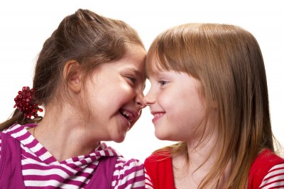 two little girls laughing with each other