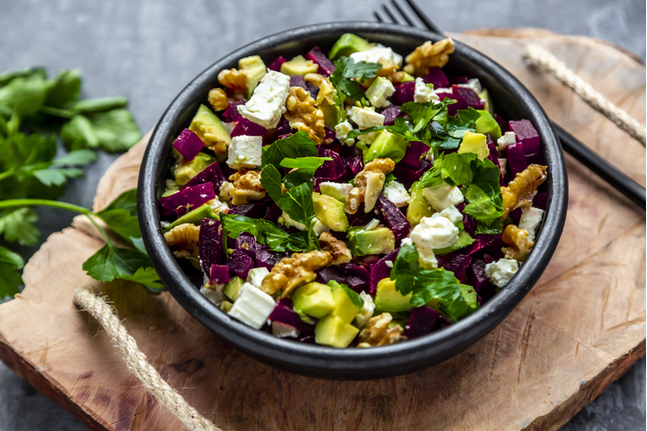 Bowl Of Beetroot Salad With Avocado, Feta, Walnuts And Parsley